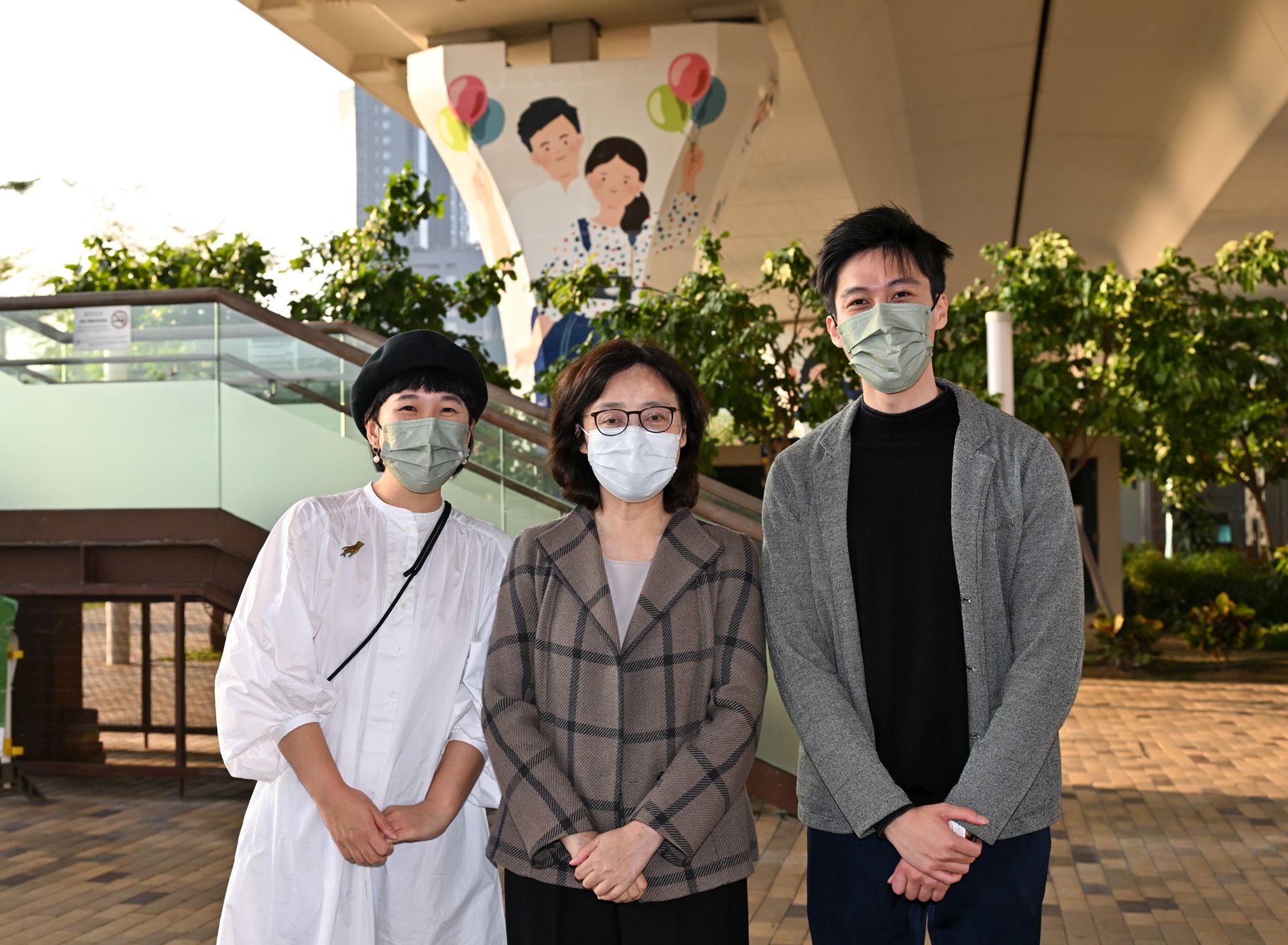 The SDEV, Ms Bernadette LINN (Centre) poses for a group photo with Derrick (right) and Annie (left), of the team that created the winning entry “Lift Up Kowloon East”.