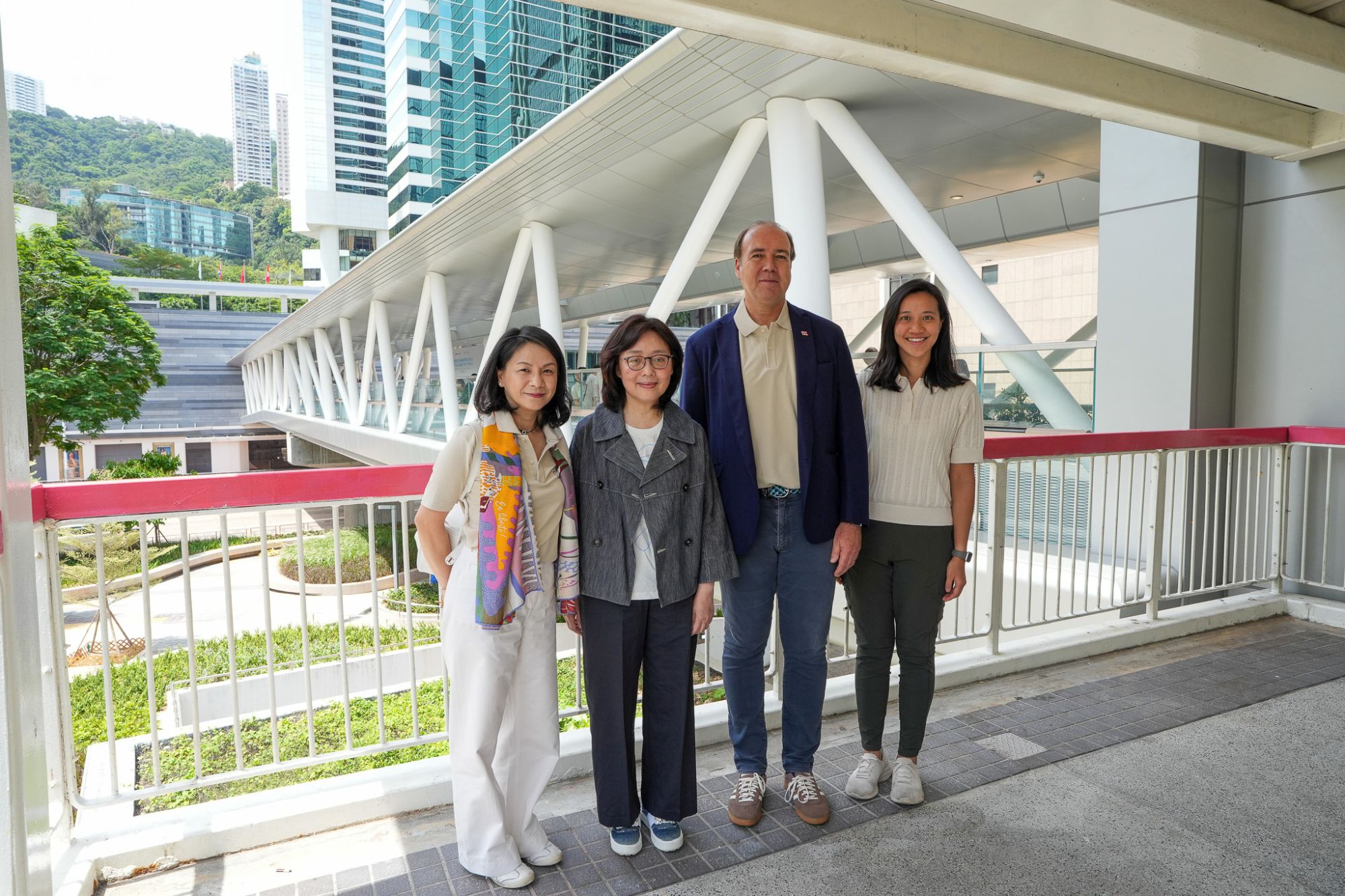 (From left) Director, Development and Valuations of Swire Properties, Ms Mabelle MA, the Secretary for Development, Ms Bernadette LINN, Chief Executive of Swire Properties, Mr Tim BLACKBURN, and the Commissioner for Harbourfront of the Development Bureau, Ms Leonie LEE, try out the newly completed Two Queensway Bridge.