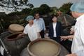 Mr Chan (second left) tours a soy sauce factory in Shek Tsai Leng to learn about its daily operation.