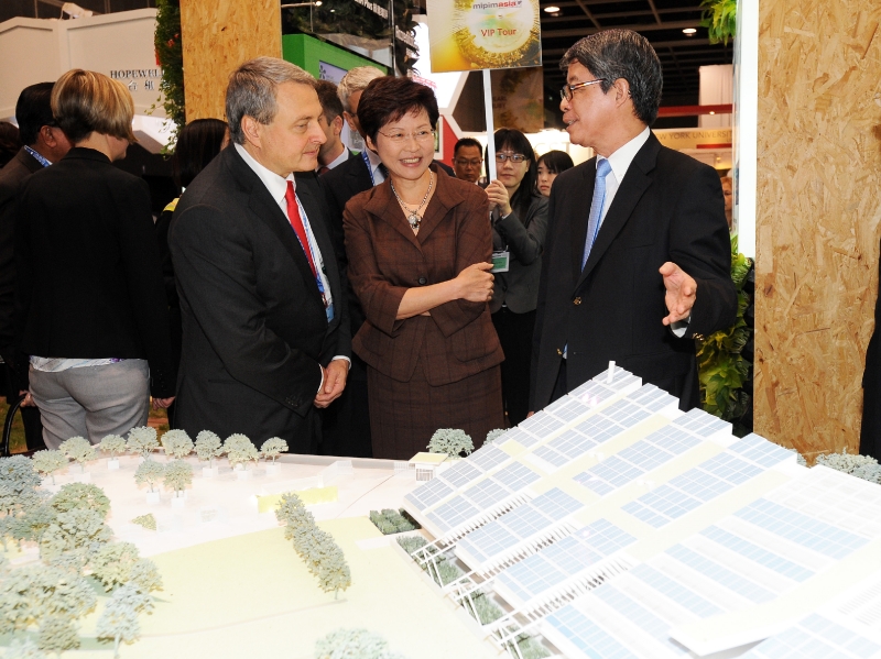 Mrs Lam and Mr Zilk listen to an introduction on the Zero Carbon Building by the Chairman of Hong Kong Green Building Council, Mr Andrew Chan, during their tour of the Hong Kong Pavilion at MIPIM Asia 2011.