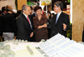 Mrs Lam and Mr Zilk listen to an introduction on the Zero Carbon Building by the Chairman of Hong Kong Green Building Council, Mr Andrew Chan, during their tour of the Hong Kong Pavilion at MIPIM Asia 2011. 