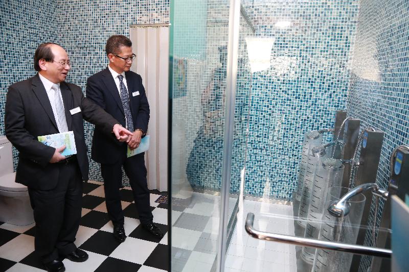 Mr Chan (right) and Mr Ma visit the Water-saving Device Showroom in the Water Resources Education Centre.