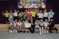The Secretary for Development, Mr Paul Chan (fifth right, front row), today (September 29) visited the Hong Kong Sheng Kung Hui Kowloon City Children and Youth Integrated Service Centre - Jockey Club Youth Express. Picture shows primary school students attending activities at the Centre presenting a self-made card to Mr Chan.