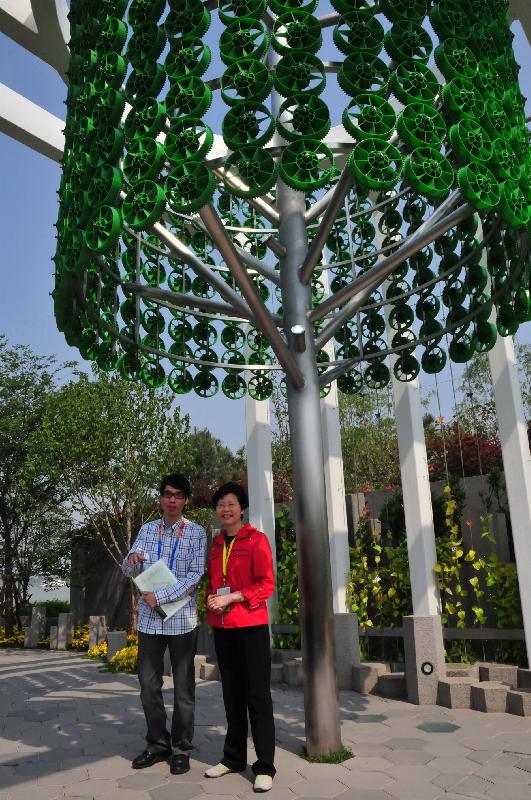 The Secretary for Development, Mrs Carrie Lam, being briefed by an officer of the Architectural Services Department on the design and attractions of the Hong Kong Garden.