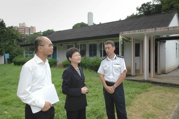 Police District Commander of Tai Po, Mr Charles Mitchell (right), briefs the Secretary for Development, Mrs Carrie Lam, today (September 10) on the history of the old Tai Po Station. On the left is District Officer of Tai Po, Mr Poon Tai-ping.