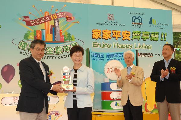 The Direct of Buildings, Mr Cheung hau-wai, represents the Buildings Department, Hong Kong Housing Society and Urban Renewal Authority, to present a souvenir to the Secretary for Development, Mrs Carrie Lam.