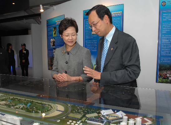 The Secretary for Development, Mrs Carrie Lam, being briefed by the Corporate Development Executive Director of the Hong Kong Jockey Club, Mr Kim Mak, on the facilities of the Equestrian Pavilion.