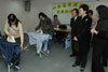 Mrs Lam watches trainees learning to iron at a domestic helper course. 