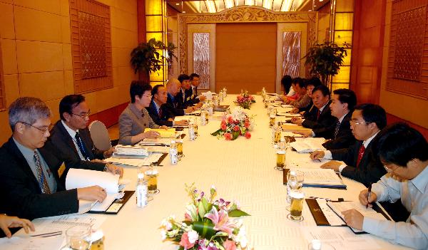 The Secretary for Development, Mrs Carrie Lam (third on the  left row) attending the meeting of the project working group on the reconstruction of the Wolong Natural Reserve  in Chengdu today (October 11).