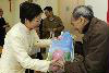 The Secretary for Development, distributing gift bags to the elderly.