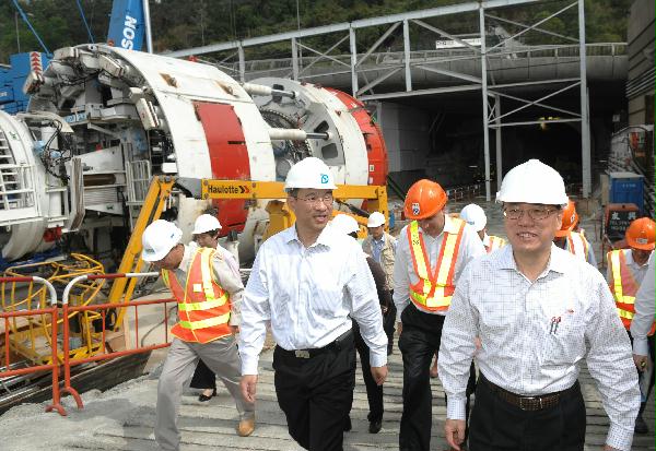 The Chief Executive, Mr Donald Tsang, accompanied by the Secretary for Development, Mrs Carrie Lam, today (February 26) visited two works sites to inspect the progress of infrastructure projects and the job opportunities generated. Picture shows Mr Tsang being briefed on the progress of the Hong Kong West Drainage Tunnel at Cyberport, Pok Fu Lam.