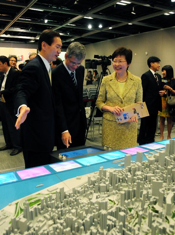The Secretary for Development, Mrs Carrie Lam, and Chairman of the Antiquities Advisory Board, Mr Bernard Chan, view a model showing the heritage buildings in Central District after attending a briefing session on 'Conserving Central'.