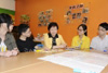 The Secretary for Development, Mrs Carrie Lam, chats in English with some secondary school students who are preparing for the coming English oral examination.