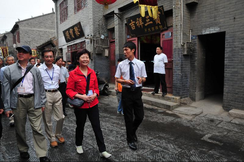 Tang (fourth left) and other officiating guests perform a lighting ceremony to mark the completion of reconstruction projects