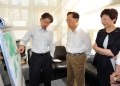 The Chief Executive, Mr Donald Tsang, today (June 9) took a helicopter ride to inspect seven potential reclamation and two potential rock cavern development sites, and visited a cavern which houses service reservoirs at Pok Fu Lam. Photo shows Mr Tsang (centre), accompanied by the Secretary for Development, Mrs Carrie Lam, being briefed by the Director of Civil Engineering and Development, Mr Hon Chi-keung, before boarding the helicopter.