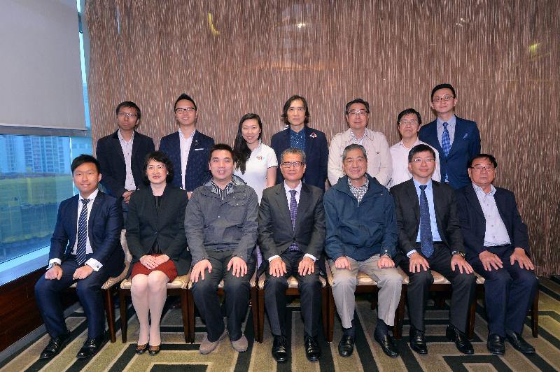 Mr Paul Chan (front row, centre) meets with members of the Tsuen Wan District Council to learn more about the latest developments of the district.