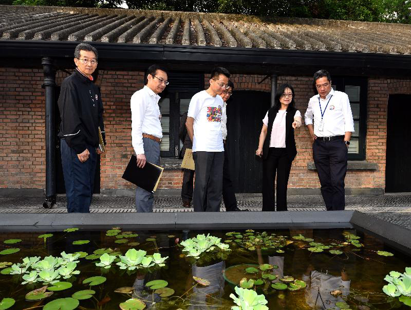 The Secretary for Development, Mr Michael Wong (first right), today (July 28) visits the Jao Tsung-I Academy and is briefed on the lotus pond called 
