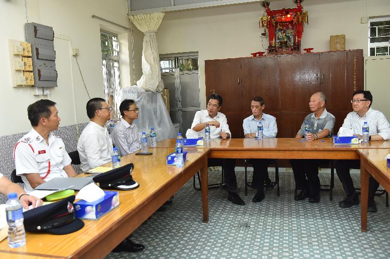 The Secretary for Development, Mr Michael Wong visited Tai O this afternoon (August 24). Photo shows Mr Wong (centre) meeting members of the Tai O Rural Committee.