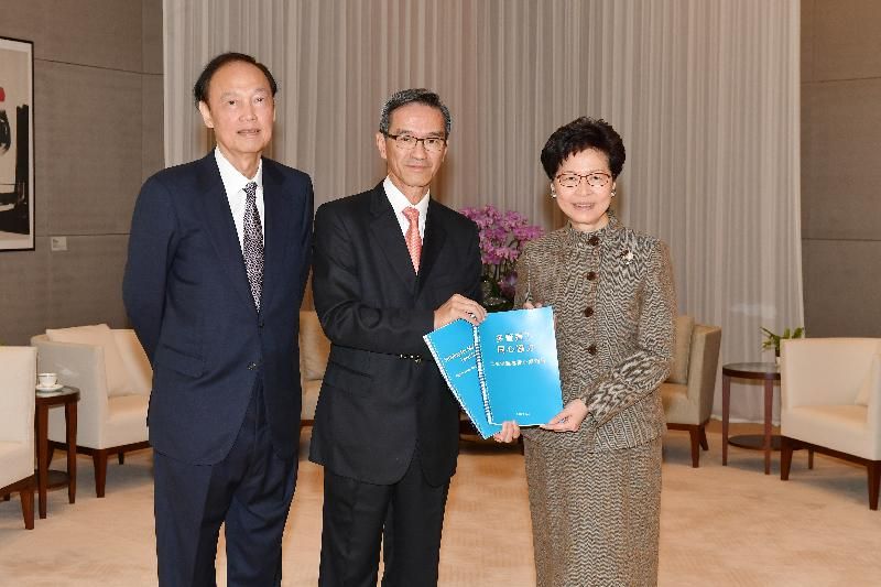 The Chief Executive, Mrs Carrie Lam (right), receives today (December 31) from the Chairman of the Task Force on Land Supply, Mr Stanley Wong (centre), and the Vice-chairman, Dr Greg Wong (left), a report on recommendations on the overall land supply strategy and prioritisation of land supply options.