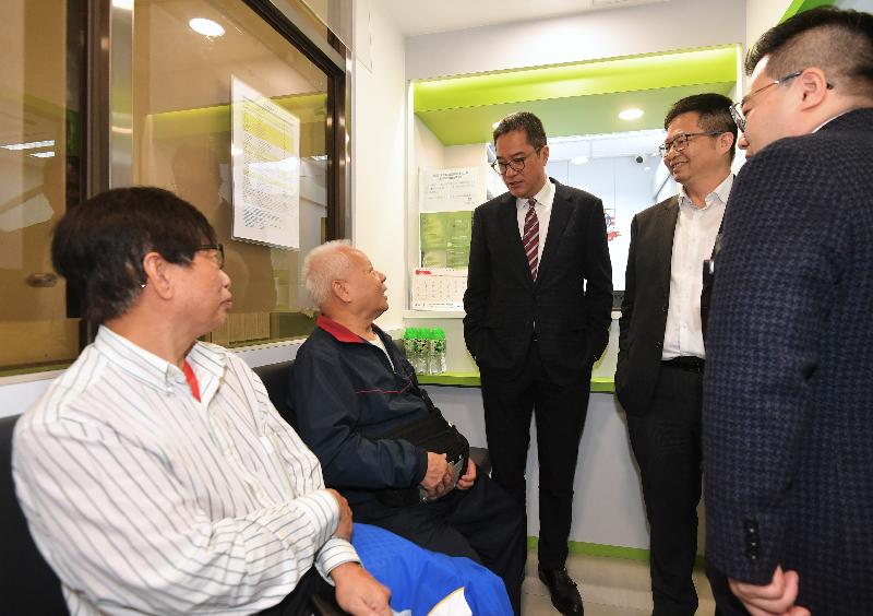 The Secretary for Development, Mr Michael Wong (centre), visited the Pok Oi Hospital Dental Service Support Base in Cheung Ching Community Centre during his visit to Kwai Tsing District today (February 18). Photo shows Mr Wong chatting with elderly people at the Support Base to learn about their daily lives and needs. Looking on is the Chairman of the Kwai Tsing District Council, Mr Law King-shing (second right).