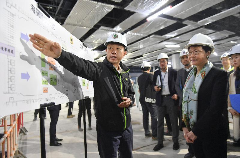The Chief Executive, Mrs Carrie Lam (second right), accompanied by the Secretary for Development, Mr Michael Wong (fourth right) and the Under Secretary for Security, Mr Sonny Au, inspected the Liantang/Heung Yuen Wai Boundary Control Point project today (March 14) to learn about the latest situation of the cross-boundary infrastructure project. Photo shows Mrs Lam being briefed by a customs officer on the future clearance arrangement.