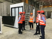 The Secretary for Development, Mr Michael Wong (second right), visited a prefabrication fitting-out factory at Jurong Port in Singapore today (January 13) to gain a better understanding of the workflow and process of assembling free-standing modular integrated construction modules. The modular unit on the left in the picture has partly completed the basic interior fitting-out as well as the appliance and facilities installation.