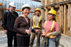 Secretary for Development, Mrs Carrie Lam, chatting with workers at the construction site to understand their work.