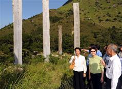The Secretary for Development, Mrs Carrie Lam (centre), was briefed on the management and maintenance of the timber columns at Wisdom Path today (September 24).