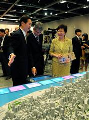 The Secretary for Development, Mrs Carrie Lam, and Chairman of the Antiquities Advisory Board, Mr Bernard Chan, view a model showing the heritage buildings in Central District after attending a briefing session on "Conserving Central".