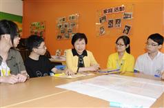 The Secretary for Development, Mrs Carrie Lam, chats in English with some secondary school students who are preparing for the coming English oral examination.