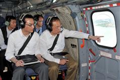Mr Tsang (right), accompanied by the Permanent Secretary for Development (Works), Mr Wai Chi-sing, gets a bird's eye view of seven potential reclamation and two cavern sites across the territory.