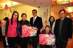 The Secretary for Development, Mr Paul Chan (third left), today (February 4) visits the Po Leung Kuk Sham Shui Po Day Care Centre for the Elderly. Photo shows Mr Chan presenting to elderly residents festive gifts and wishing them good health and happiness. also present are the Principal Social Services Secretary (Elderly and Rehabilitation Services) of the Po Leung Kuk, Mr Lam Muk-kwan (first right); the Assistant Principal Social Services Secretary (Elderly Services), Ms Nina Ng (second right); and the Centre-in-charge, Ms Tam Hau-lan (first left).