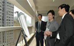 Mrs Lam being briefed by representatives of the Urban Renewal Authority on the proposed revitalisation plan for Chung On Street.