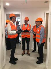 The Secretary for Development, Mr Michael Wong, today (January 14) visited a private high-rise development project adopting the modular integrated construction method. Photo shows Mr Wong (first left) and the Permanent Secretary for Development (Works), Mr Lam Sai-hung (first right), visiting module units with basic interior fitting-out completed.