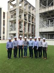 The Secretary for Development, Mr Michael Wong, today (January 14) visited an integrated construction and prefabrication hub to observe how different processes of manufacturing prefabricated construction units are consolidated in a single multi-storey factory to optimise land use. Photo shows Mr Wong (third left); the Permanent Secretary for Development (Works), Mr Lam Sai-hung (first left); the Principal Government Engineer, Mr John Kwong (fourth right), and representatives of the factory in front of the multi-storey prefabrication unit storage area.