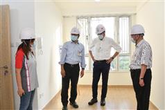 The Financial Secretary, Mr Paul Chan, today (August 24) attended the topping-out ceremony of the Disciplined Services Quarters for the Fire Services Department at Pak Shing Kok, Tseung Kwan O. Photo shows Mr Chan (second left), accompanied by the Secretary for Development, Mr Michael Wong (third left), inspecting a quarter unit built using Modular Integrated Construction method.