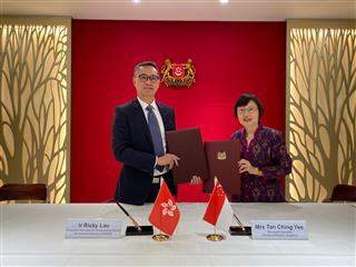 The Permanent Secretary for Development (Works), Mr Ricky Lau (left), and the Permanent Secretary of the Ministry of Finance of Singapore, Mrs Tan Ching Yee (right), signed a Memorandum of Understanding in Singapore today (December 1) to enhance expertise and experience exchanges in infrastructure project management and delivery.
