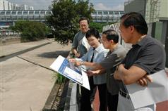 The Secretary for Development, Mrs Carrie Lam, today (September 29) is briefed by the Director of Drainage Services, Mr Wong Chee-keung (second from right), on the flood prevention operation of the Yuen Long Nullahs. Looking on is the Permanent Secretary for Development (Works), Mr Mak Chai-kwong (first from right). 