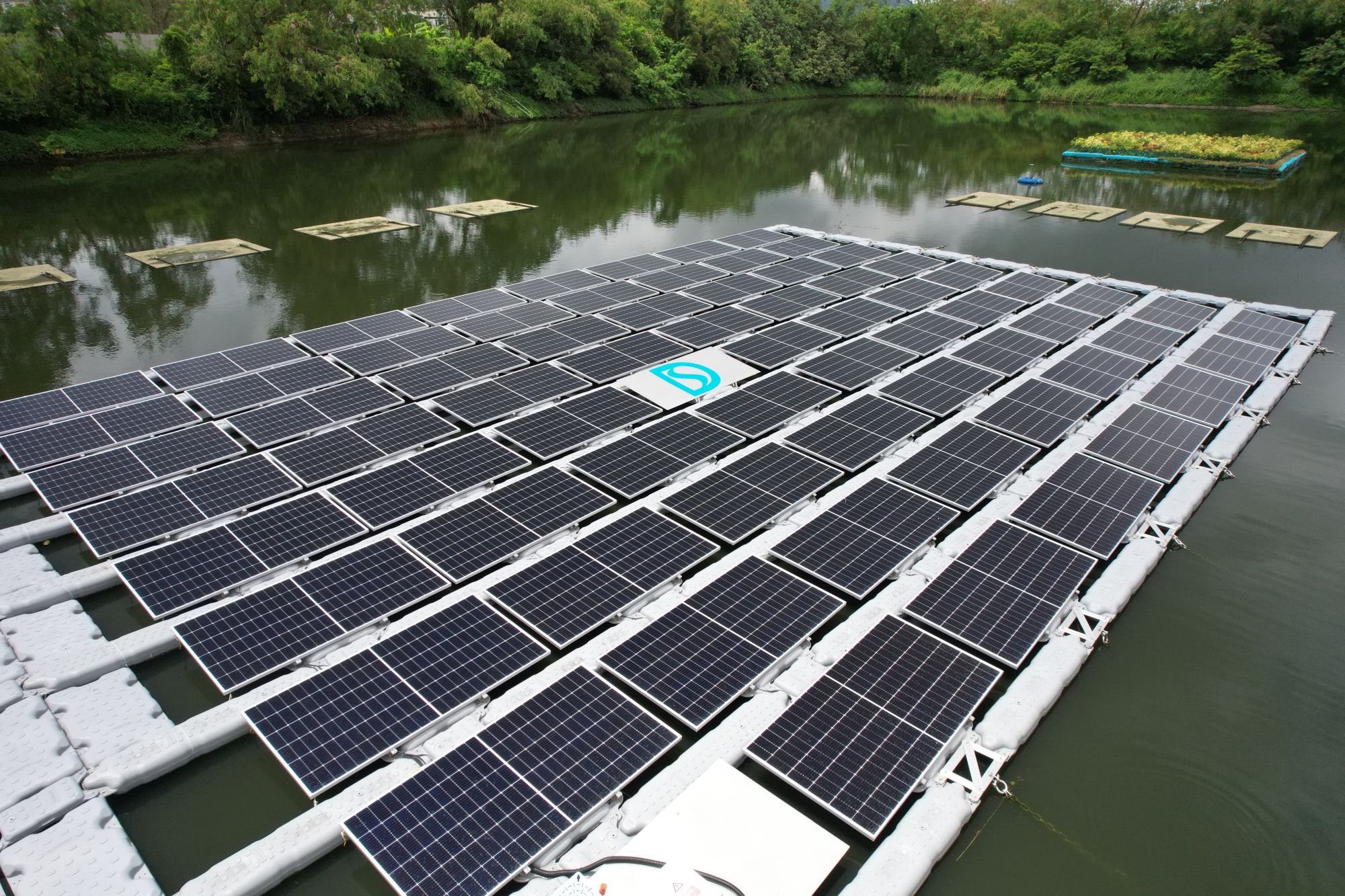 新田鄉村防洪計劃的蓄洪池，池面面積約16 400平方米，提供了合適的場地作為部門首個浮式太陽能發電系統的試點。