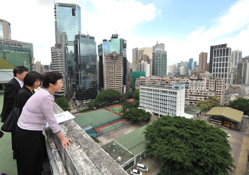 The Secretary for Development, Mrs Carrie Lam, was briefed by Planning Department officer on the roof of the former headquarters of the Electrical and Mechanical Services Department about land use planning issues in the Caroline Hill area.